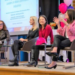 Four people talking on stage