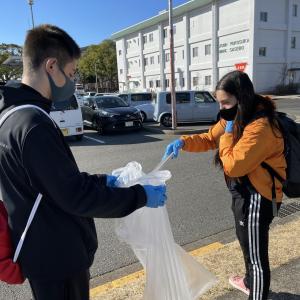 two people picking up litter