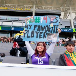 A student holds up a sign
