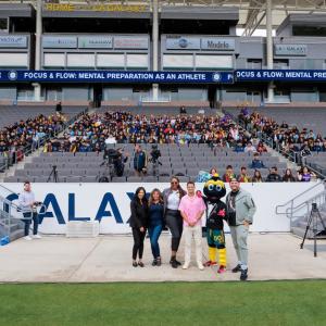 People standing together in front of an audience
