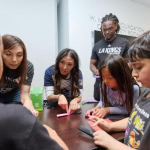 Children from Little Tokyo Service Center learn about hockey with the LA Kings Ice Crew.