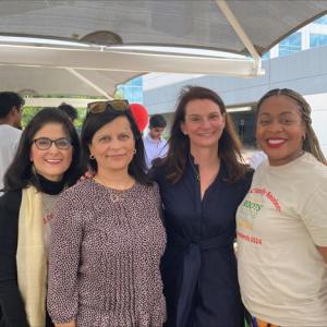 A group of women standing under a canopy