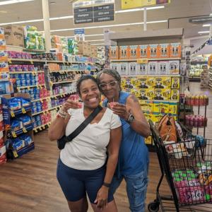 Two women posing for a picture in a store