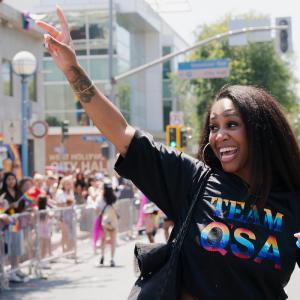 Team QSA marches with bubbles and peace sign in air