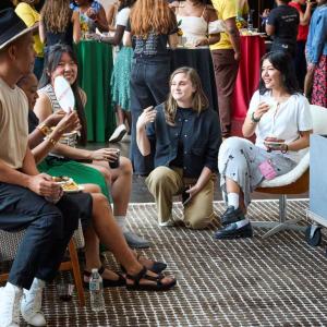 A group of men and woman sitting and talking