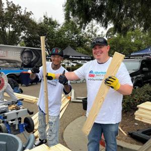 People posing with wood planks