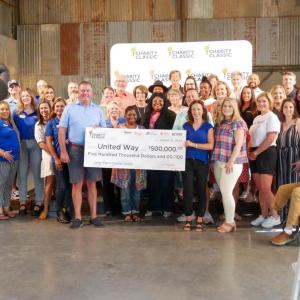 Group of people holding a check
