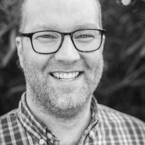 Black & white headshot of Logan Duran