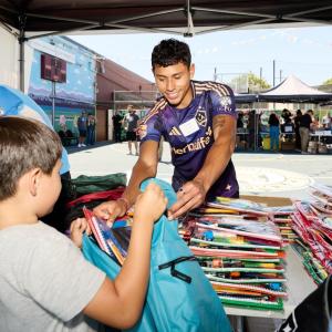 LA Galaxy midfielder Edwin Cerrillo helped hand out school supplies to students.