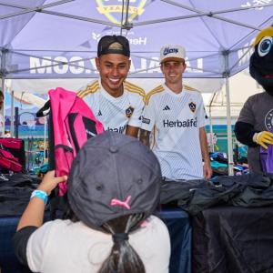 LA Galaxy players handed out backpacks filled with school supplies to students.