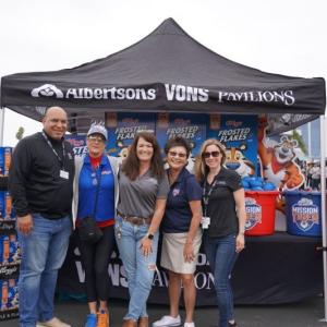 Group of people smiling in front of Albertsons' tent