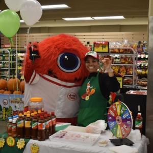 Jewel-Osco's JoJo mascot poses with person hosting booth.