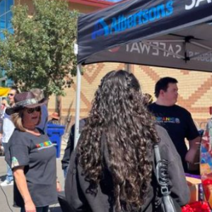 Group of people standing under Albertsons' tent