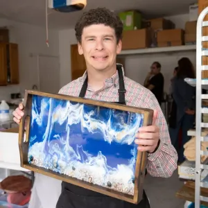 A person holding up a piece of work