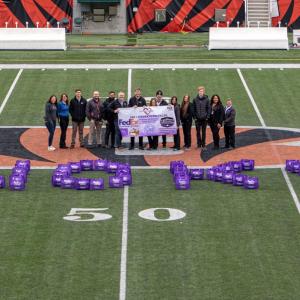 A group of people stood on a football pitch 