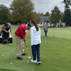 Participants, volunteers, and caregivers at the 2023 Stars, Stripes, and Links Event at Sand Ridge Golf Club in Chardon, Ohio.