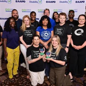 A group photo in front of a Disability:IN Conference back drop 