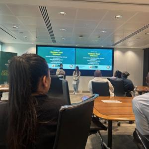 Two people stood up in front of a room of people