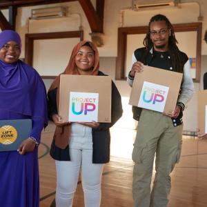 people holding up Project Up boxes