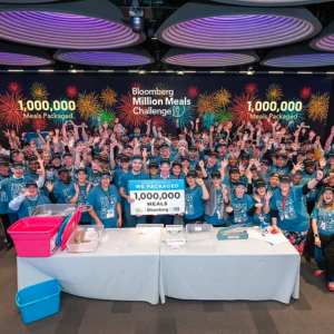 Group cheers together with sign
