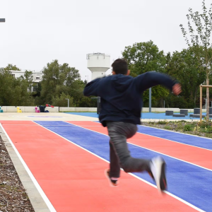 Person running on blue and red course