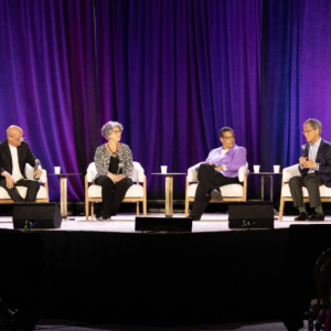 People sat on stage in front of an audience at the 2024 WELL Conference