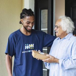 A meal is delivered to a Meals on Wheels recipient