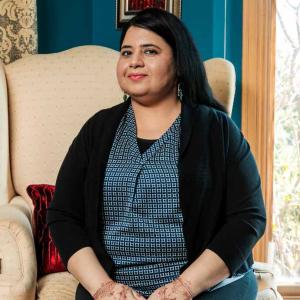 Syeda Ahmed sat on an arm chair 
