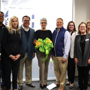 People standing together with a ribbon