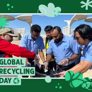 People placing things into a plastic bag: Global Recycling Day