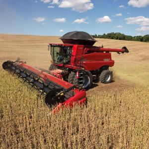 Red farm machine in a golden field