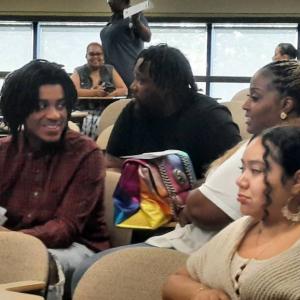 People talking in a classroom.