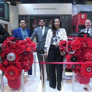 People posing with red engines