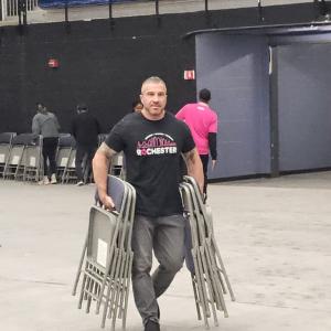 Person carrying chairs