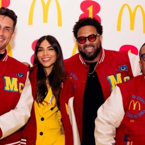 Four people standing together in McDonald's letter jackets