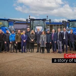 People standing together in front of blue machinery
