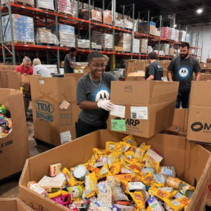 People in Motorola t-shirts working with boxes in a warehouse