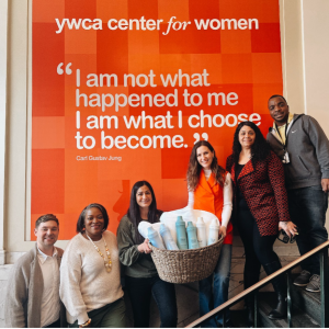 People standing on a stairway with a basket of products