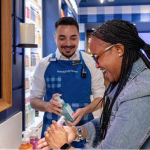 A Bath & Body Works employee helping a customer