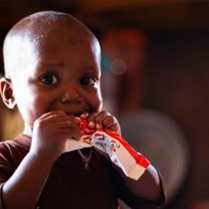 A child eats RUTF.