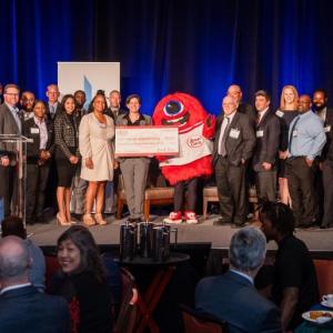 Group of people holding a check