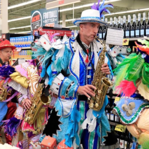 People dressed up for Italian-Heritage Month playing instruments