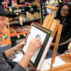 Someone drawing caricatures of two girls