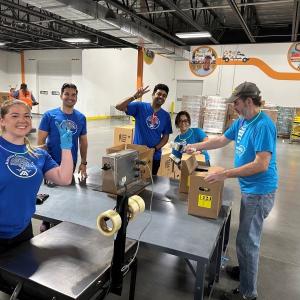 Albertsons associates packing up food boxes at North Texas Food Bank for donations.