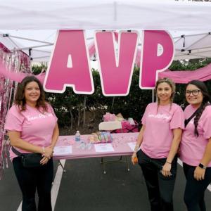 People at booth with "AVP" sign