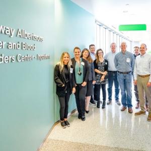 Group of people next to the new Safeway Albertsons Cancer and Blood Disorders Center sign