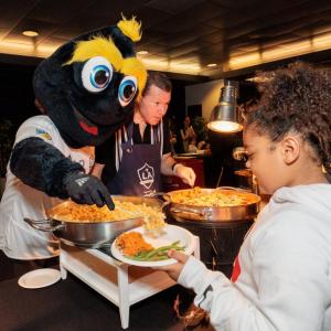 LA Galaxy mascot Cozmo helps serve meals to families in need at the the 20th annual Thanksgiving Foundations’ Feast at Dignity Health Sports Park in Carson, CA.