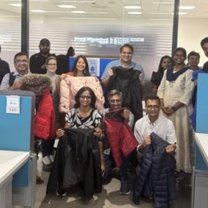 Group of people posing with winter coats