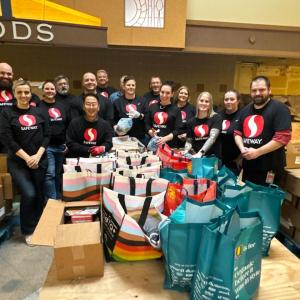 Group of people with Safeway shirts posing for picture