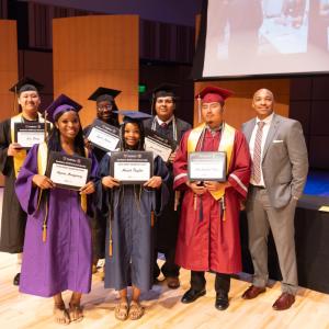 Students holding scholarship certificates